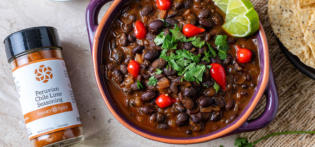 Jar of Peruvian Chile Lime Seasoning with a bowl of black bean soup