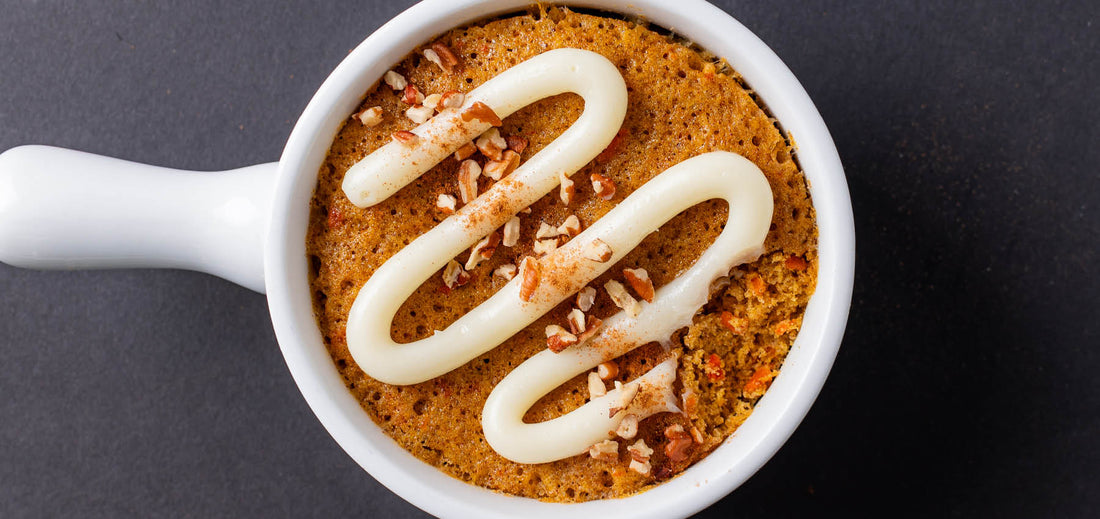 Overhead view of finished Spiced Carrot Mug Cake with icing drizzle