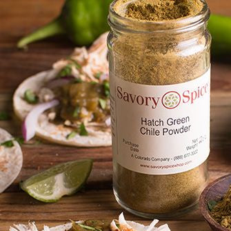 Jar of Hatch Green Chile Powder with chiles and tacos