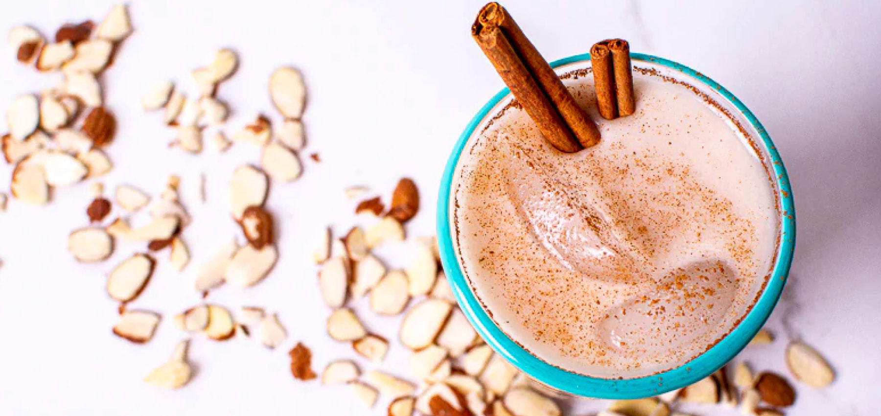 Horchata with cinnamon sticks and sliced almonds