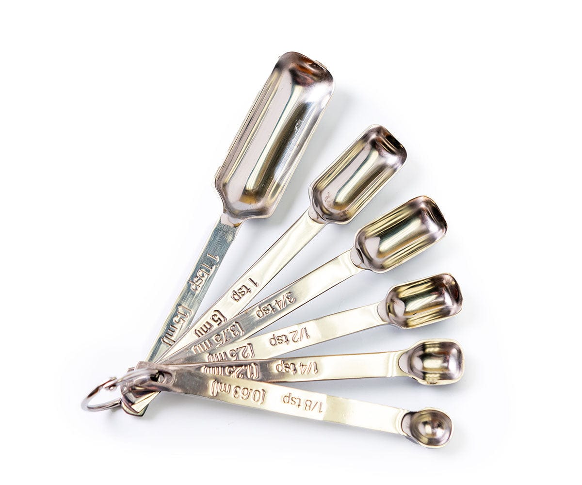 Set of 6 silver measuring spoons fanned out. 