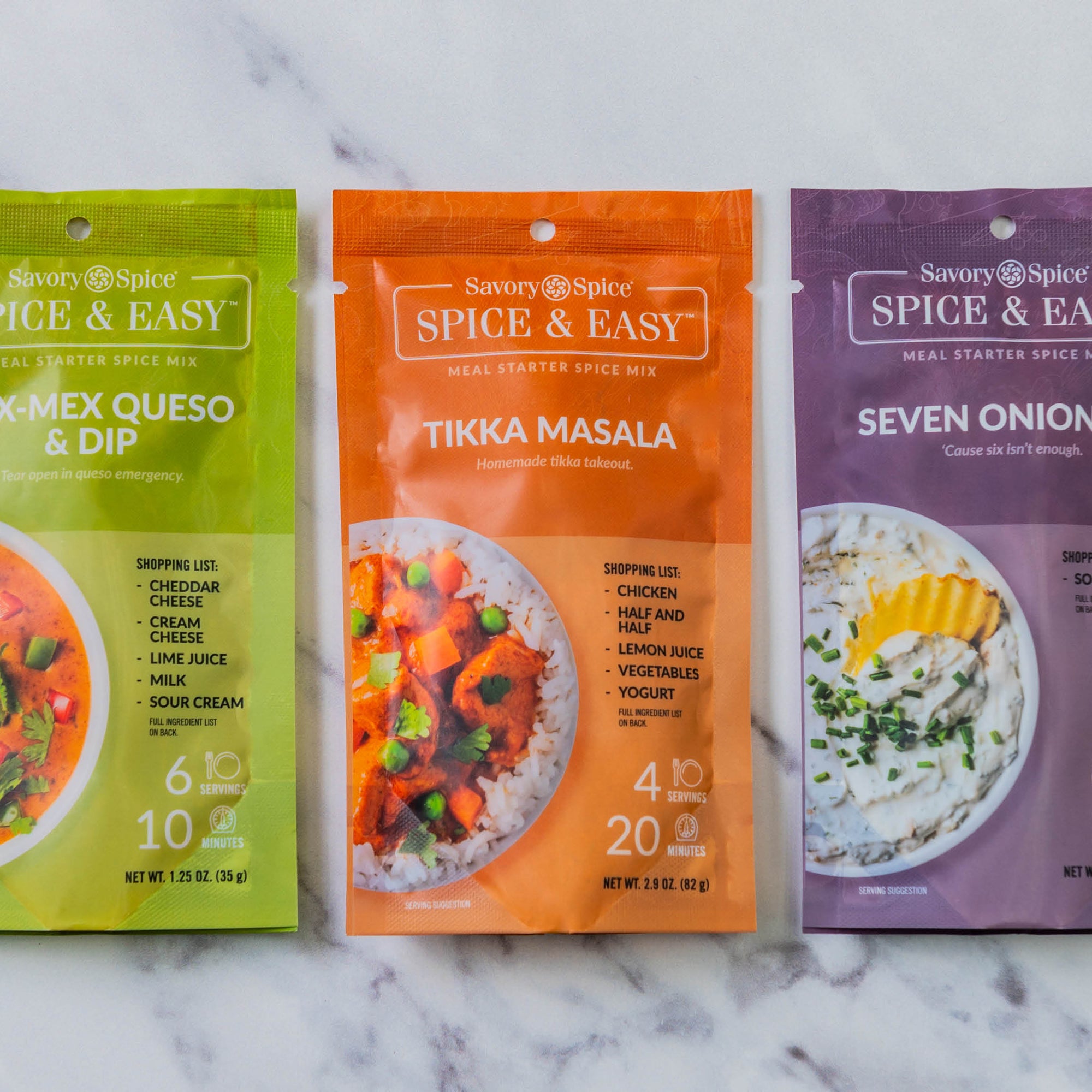 Huli Huli Chicken, Tex-Mex Queso & Dip, Tikka Masala, Seven Onion Dip, and Butter Chicken Spice & Easy Meal Starter Spice Mixes on marble background
