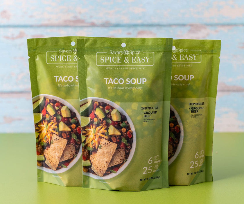 Three Taco Soup Packets on a green table with a light blue wood background
